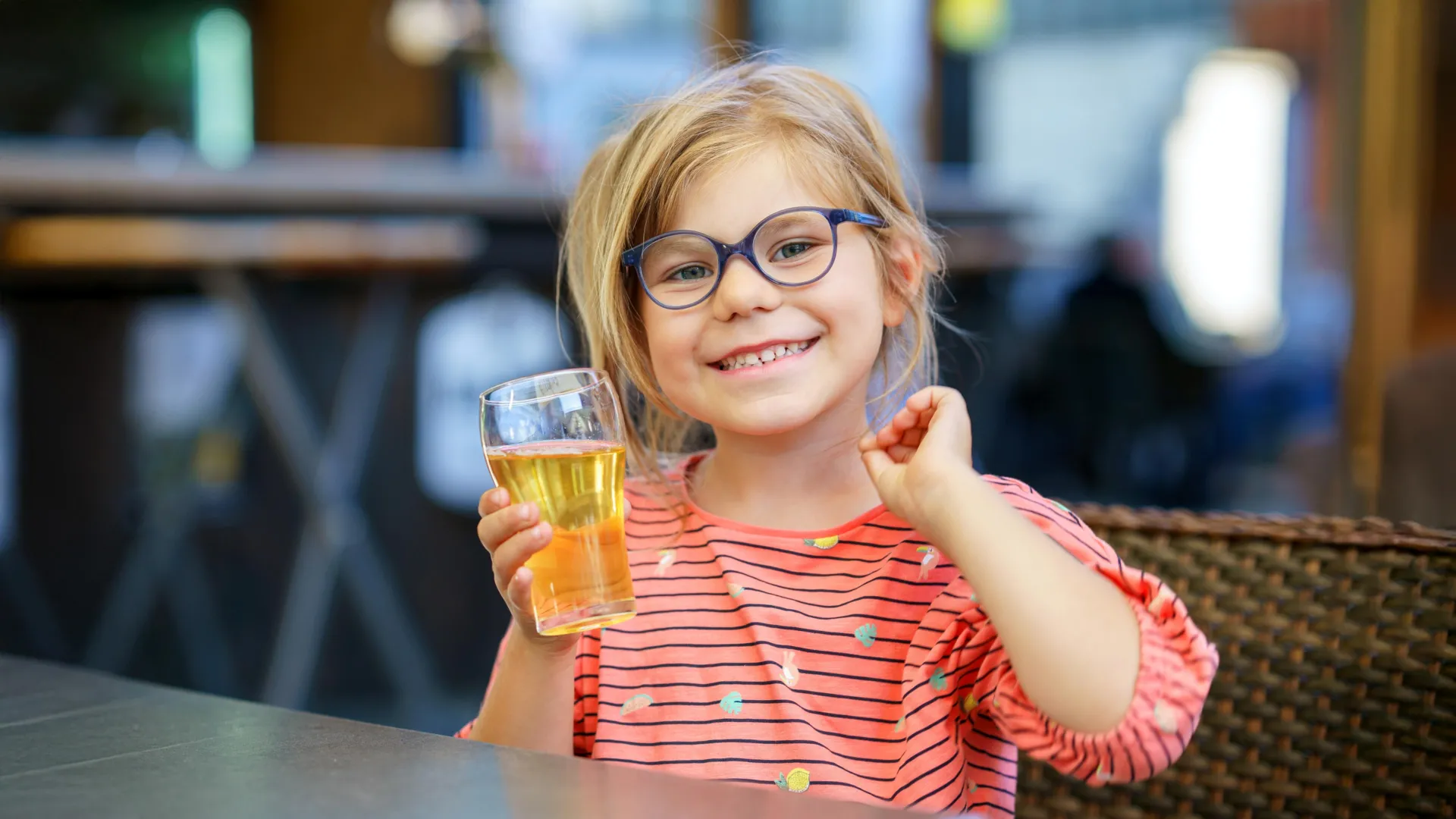 happy smiling little girl drinking juice