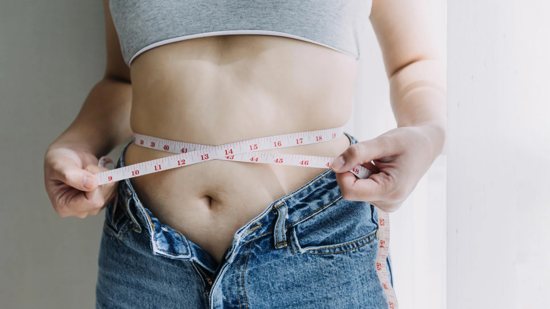 woman measuring tape belly fat weight loss